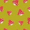 Pattern with fly agaric on a khaki background, red poisonous mushrooms with white spots. Vector illustration