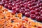 Pattern of fresh mellow cherries and apricots prepared for cooking