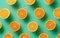 Pattern of fresh oranges over green background.