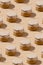 Pattern from glass jar with honey under kraft paper on a string on beige background. Sweet food monochrome concept.