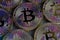 Pattern of golden Bitcoin coins with purple reflections