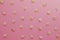 Pattern of grains of oats on a pink background.