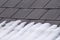 A Pattern of Grey Slates on a Roof with Melting Snow