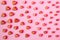 A pattern of hearts of different sizes on a pink background