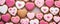 Pattern of homemade valentine cookies on pastel pink background.