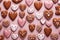 Pattern of homemade valentine cookies on pastel pink background.
