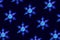Pattern with interlaced snowflakes on dark blue background