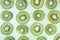 Pattern of kiwi slices levitating above green background