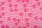 Pattern with light pink and dark pink glass glossy hearts on pink background.