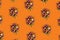 Pattern made of bouquet of dried flowers on pastel orange background. Autumn flowers concept