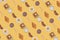 Pattern made with fried eggs, slices of crispy bacon, toast bread, croissant and glasses of milk on yellow background