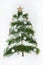 The pattern is made of pine branches on a white background and decorated with white snowflakes and wooden toys. Christmas, winter,