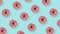 Pattern made of pink donuts on blue background