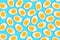 Pattern of many boiled cut eggs on a blue background