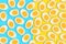 Pattern of many boiled cut eggs on a blue and yellow background