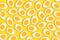 Pattern of many boiled cut eggs on a yellow background