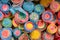 pattern of multicolored spirals of chewing marmalade on a candy store window