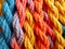 Pattern of multicolored twisted and intertwined ropes and threads.