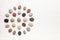 Pattern of natural multicolored pebbles on white wooden background.