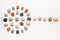 Pattern of natural multicolored pebbles on white wooden background.