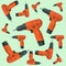 Pattern of orange cordless drills on a light background.