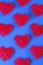 Pattern of the red hearts on the cornflowerblue background.
