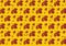 A pattern of red maple leaves and cut-out notes on a yellow background. The concept of autumn music