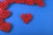 Pattern of the red wicker hearts on the cornflowerblue background.