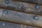 Pattern a row of old weather-beaten planks part of a board a boat bound by an iron riveted corrosion background