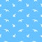 A pattern of silhouettes of Ivory gulls on a blue background. Vector flat illustration.