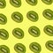 Pattern of sliced kiwis isolated on an yellow background for print