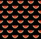 Pattern with slices of watermelon of different sizes on a black background