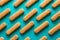 Pattern of sponge fingers cookies Savoiardi, Ladyfinger, biscuit on blue background. Top view. Flat lay