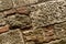 Pattern stone from brown cobblestones oblique background close up