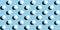 A pattern of white ping pong balls as spheres isolated on uniform blue background. Banner size.