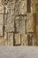 Pattern yellow color of ancient style design decorative uneven cracked real stone wall surface with cement. Old sacred tomb facade
