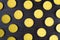 Pattern of yellow scented candles on a dark texture background, top view, flat lay
