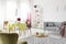 Patterned carpet on the floor of stylish living room with grey couch, round table and chairs and heather paintings on the wall