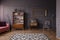 Patterned carpet in spacious grey retro living room interior wit