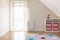 Patterned colorful carpet in kid`s room interior with shelves an