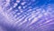 Patterned fluffy purple or ultra violet clouds in blue sky