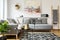 Patterned pillows on grey corner sofa in living room interior wi