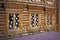 Patterned Windows in the old Russian log hut. Well-developed wood structure of the log.