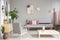 Patterned wooden armchair next to table in grey flat interior wi