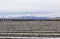 Patterns of Snow In Plowed Fields Mountain Background