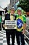 On Paulista avenue, an elderly man holds a sign that reads: `I want to be heard by omission of the truth`