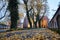 Paved alleyway and medieval church during autumn