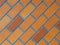 Paved brick background photograph, glazed brown on diagonal slant.