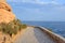 Paved coastal walkway on a summer evening