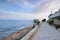 Paved coastal walkway on a summer evening